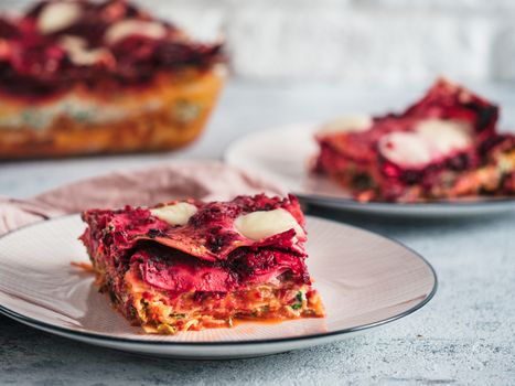 Vegetable Packed Rainbow Lasagne on pink plate. Ideas and recipes for healthy vegetarian dinner or lunch. Lasagne with beetroot, pumpkin, mushrooms, ricotta, spinach, mozarella