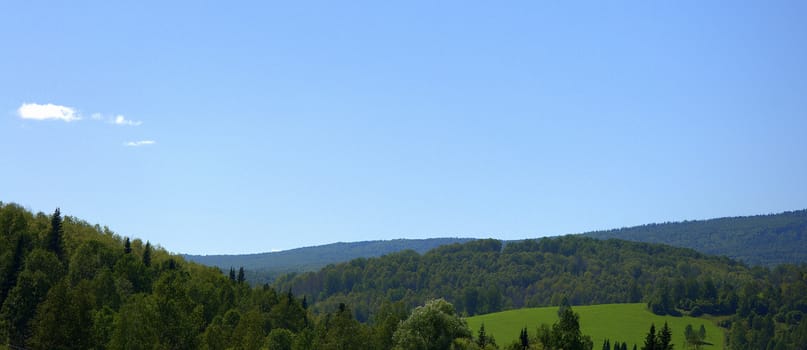 Panoramic shot of a fertile valley in the Altai mountains. The Republic of Gorny Altai, Siberia, Russia.