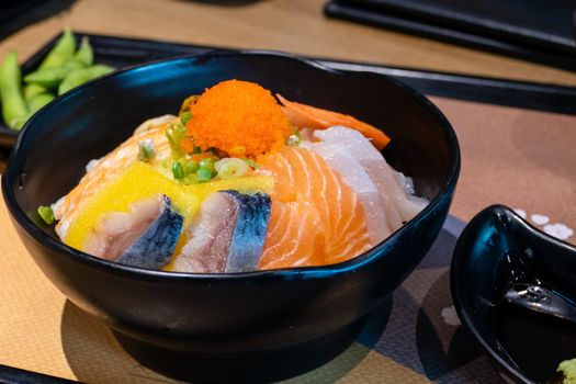 Sashimi in bowl with fish eggs and rice