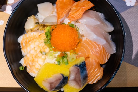 Sashimi in bowl with fish eggs and rice