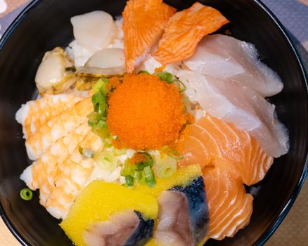 Sashimi in bowl with fish eggs and rice