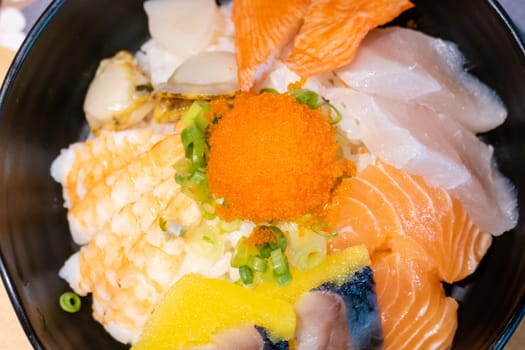 Sashimi in bowl with fish eggs and rice