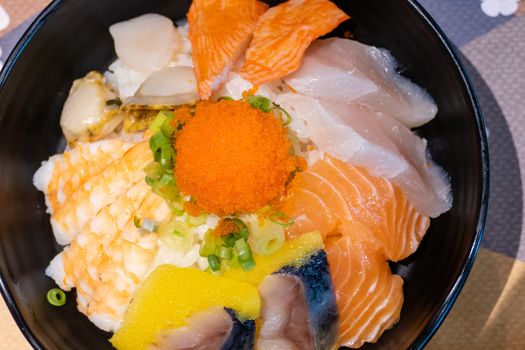 Sashimi in bowl with fish eggs and rice