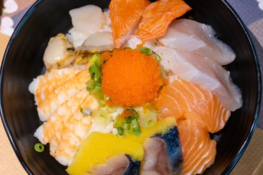 Sashimi in bowl with fish eggs and rice