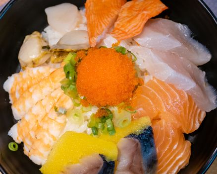 Sashimi in bowl with fish eggs and rice