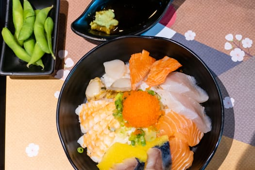 Sashimi in bowl with fish eggs and rice