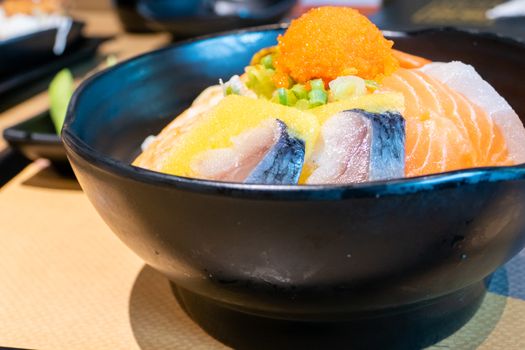 Sashimi in bowl with fish eggs and rice