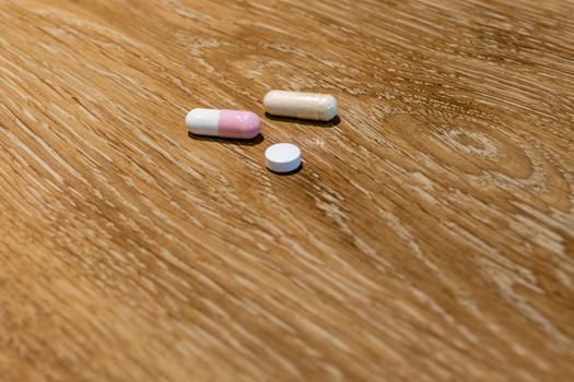 Capsules and pill on table, medical concept