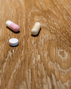 Capsules and pill on table, medical concept