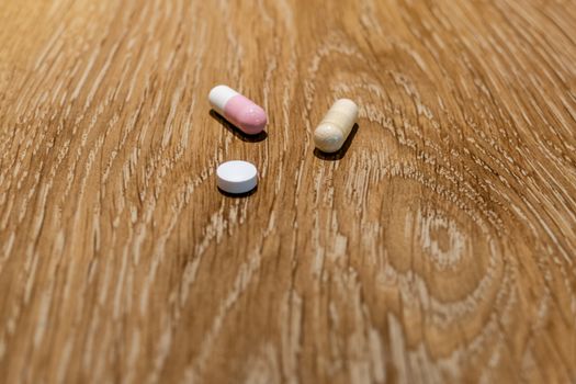 Capsules and pill on table, medical concept