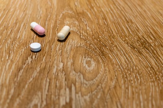 Capsules and pill on table, medical concept