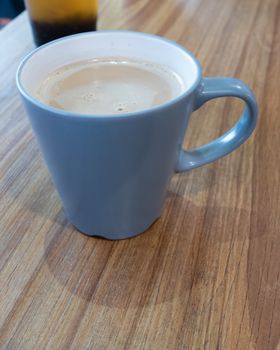 Coffee with milk in mug on table