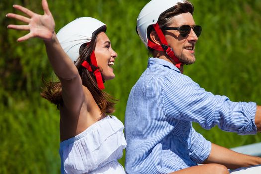 Happy couple on a scooter at summer vacation