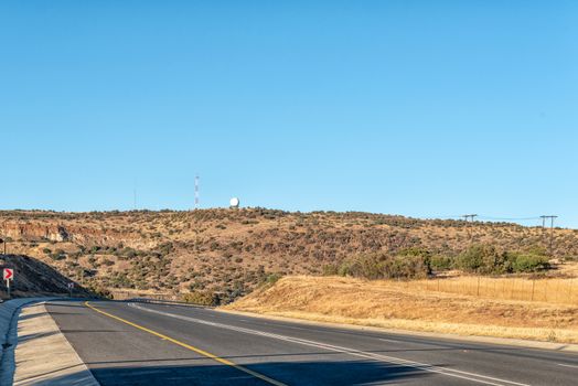 A view of the N8-road to the west of Bloemfontein in the Free State Province of South Africa. A weather radar system and cellphone tower is visible