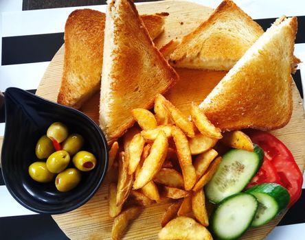 cheddar cheese fried toast. served with potato fries and olives