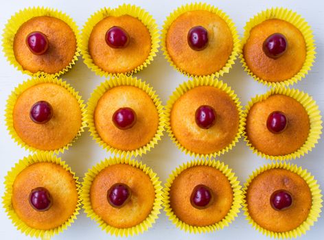 Tasty homemade cherry cupcakes isolated on white ground. Top view.