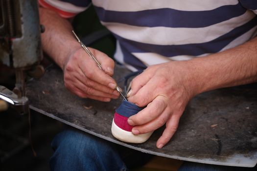 Cobbler. The master worker who repairs the shoe