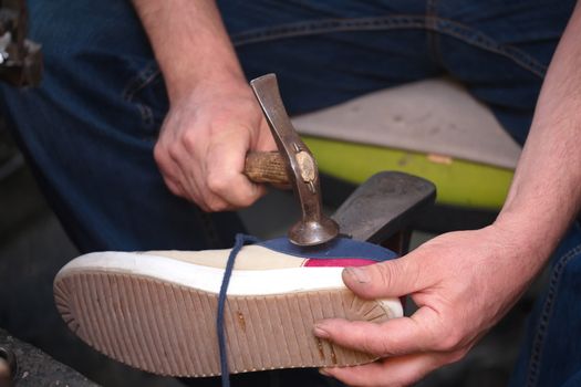 Cobbler. The master worker who repairs the shoe