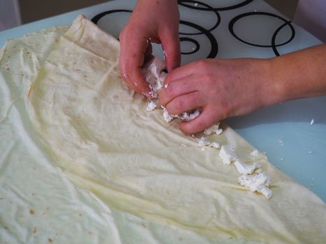 she prepares a woman cheese patty.