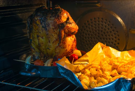 chicken and potatoes fried in the oven, With cooked tomatoes and onions