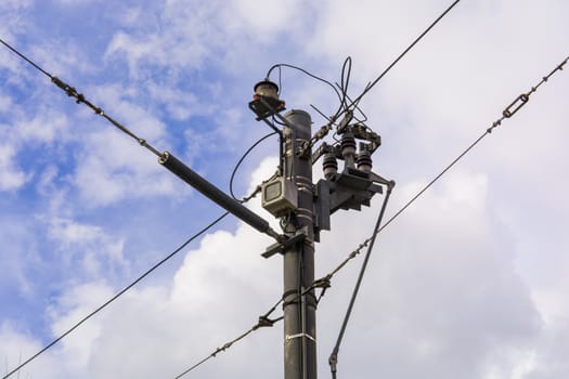 small transformer on the electric pole. city, mains electricity. high voltage line