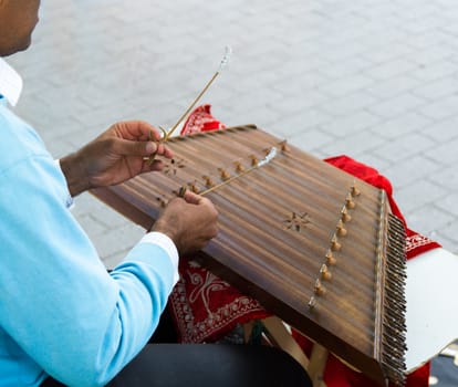 Santur is a percussion instrument of Persian / Iranic origin. played with tiny hammers