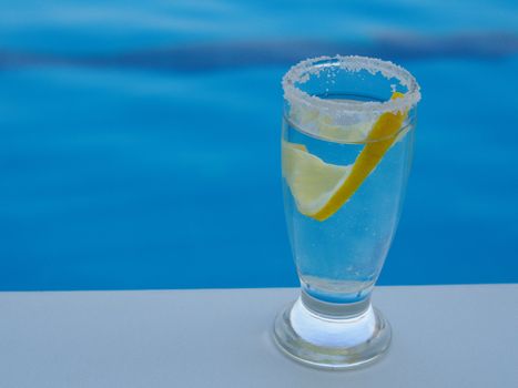 fresh lemon and salted tequila shot by the pool