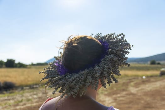 beautiful woman wearing crown of lavender. made of lavender flowers.