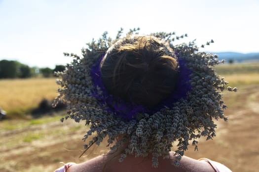 beautiful woman wearing crown of lavender. made of lavender flowers.