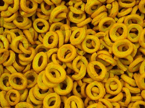 ring chips made of roasted chickpea powder. top view chips background