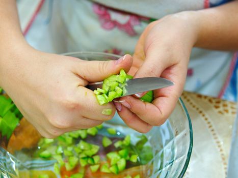 prepare a salad. prepare a salad. cleanses cucumber shells with women's hands. cucumber is cleaned with a peeling knife. Preparing for meals