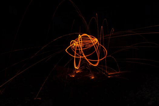 Drawing light at night in an old abandoned building, splashes of light and sparks. Freezelight