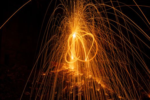 Drawing light at night in an old abandoned building, splashes of light and sparks. Freezelight