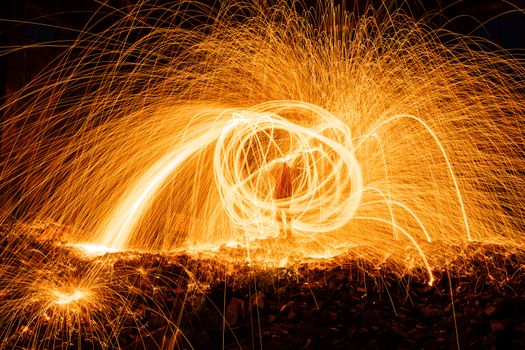 Drawing light at night in an old abandoned building, splashes of light and sparks. Freezelight