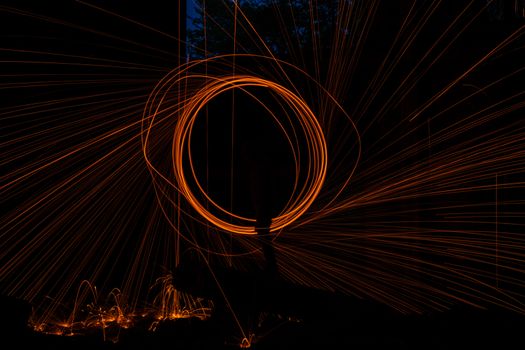 Drawing light at night in an old abandoned building, splashes of light and sparks. Freezelight