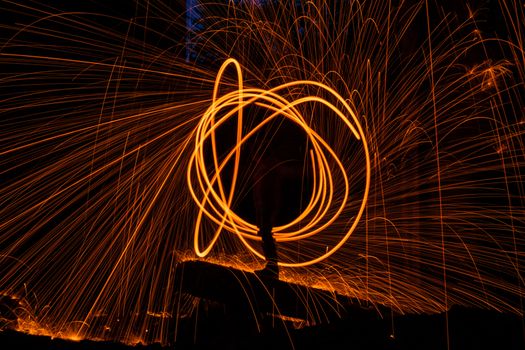 Drawing light at night in an old abandoned building, splashes of light and sparks. Freezelight