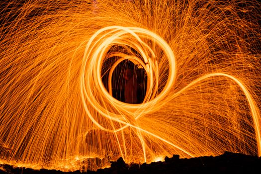 Drawing light at night in an old abandoned building, splashes of light and sparks. Freezelight