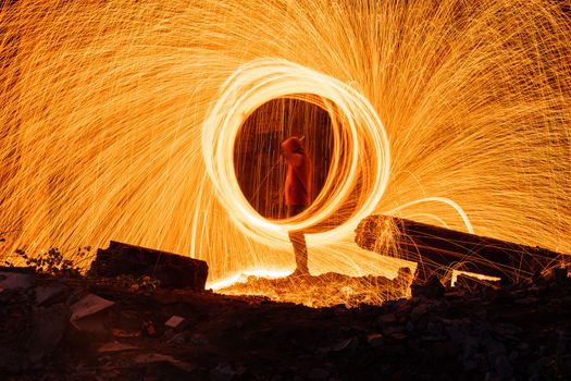 Drawing light at night in an old abandoned building, splashes of light and sparks. Freezelight