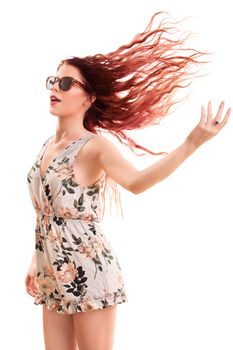 Portrait of a beautiful young girl wearing sunglasses, jumping and playing with her hair, isolated on white background.