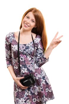 A portrait of a beautiful young girl holding a vintage camera and gesturing with her hand, isolated on white background.