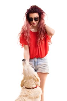 Beautiful young redhead girl with sunglasses, petting her dog preparing to go out for a walk, isolated on a white background.