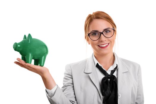 A portrait of a businesswoman holding a piggy bank, isolated on white background.