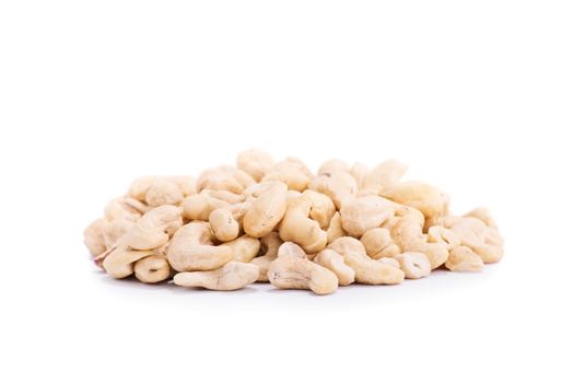 Close up shot of heap of cashews, isolated on white background.