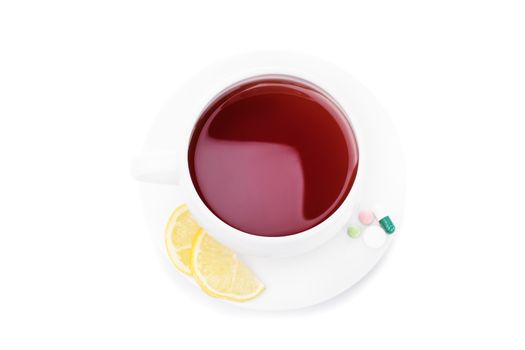 Cup of tea with slices of lemon and pills, isolated on white background.