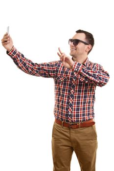 A portrait of a young fashionable man taking a selfie, isolated on white background.