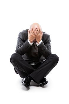 Business problems and failure at work concept - unhappy crying tired or stressed businessman sitting in depression hand hiding face white isolated