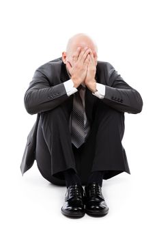 Business problems and failure at work concept - unhappy crying tired or stressed businessman sitting in depression hand hiding face white isolated