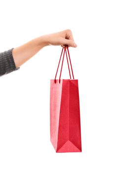 A close up shot of a female hand holding a shopping bag, isolated on white background.