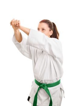 Offense-Defense. Young girl wearing kimono with green belt, practicing defense, isolated on white background.