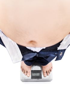 Top view of a young male with big stomach and weight problems standing on a scale, isolated on white background.